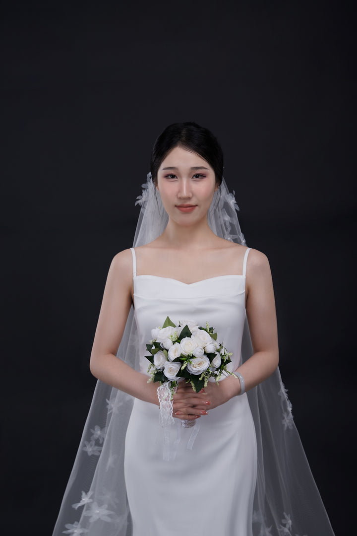 Bride with luxury long wedding veil with 3D flowers.