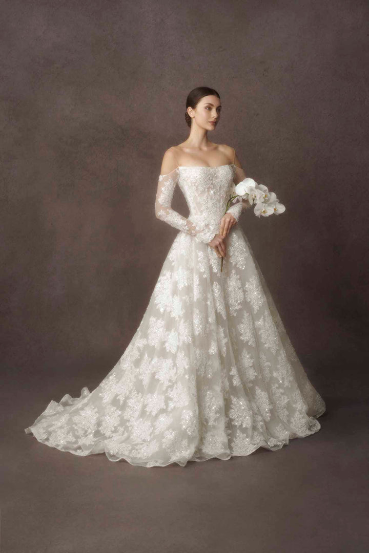 Long sleeve lace ballgown by Nicole Felicia Couture at Estrelle Bridal Toronto.