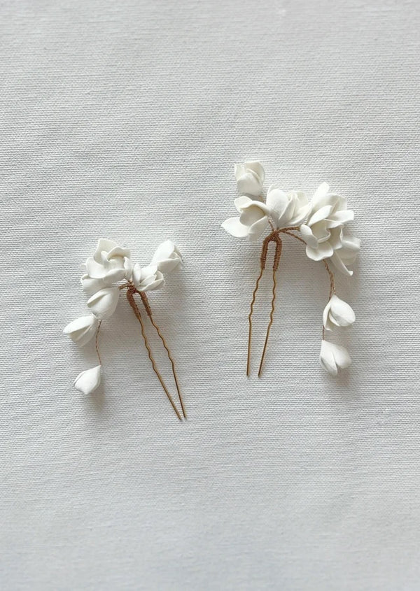Hand sculpted white flowers bridal accessories, a pair of hair pin by Vivi Embellish available in Estrelle Bridal Toronto.