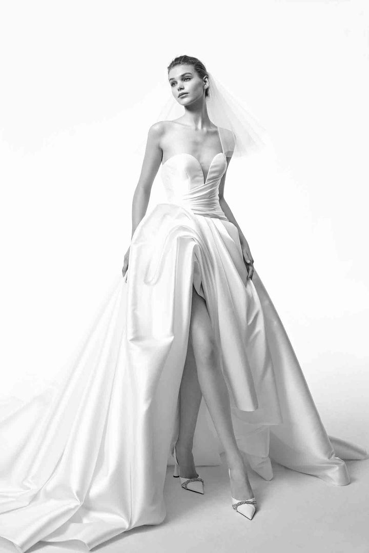 Contemporary and chic strapless asymmetrical wedding gown with sculpted skirt made by Nicole Felicia Couture at Estrelle Bridal Toronto.
